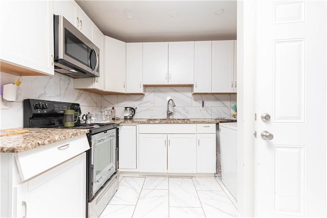 kitchen featuring marble finish floor, electric range oven, stainless steel microwave, white cabinetry, and a sink