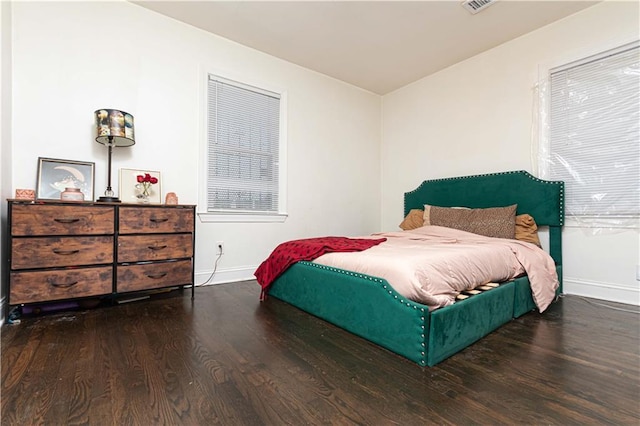 bedroom with baseboards and wood finished floors