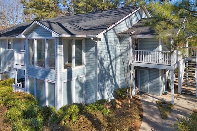 view of side of home with a balcony and central AC unit