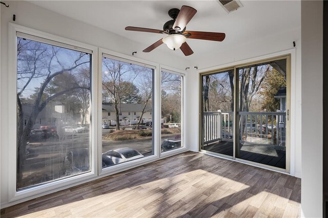 unfurnished sunroom featuring ceiling fan