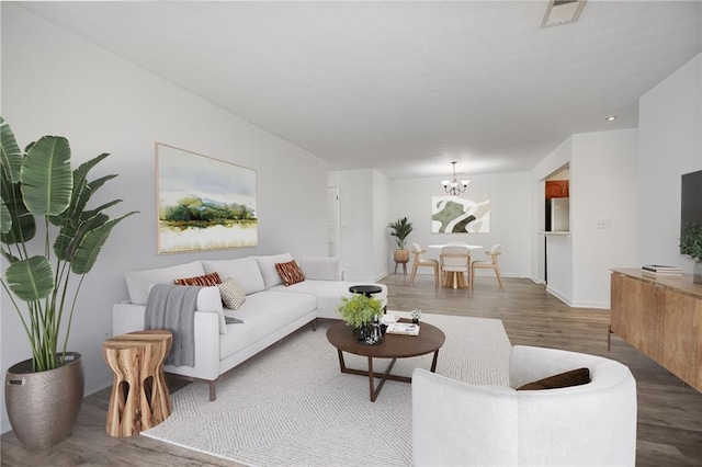 living room with a chandelier and hardwood / wood-style floors