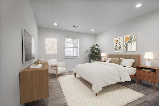 bedroom with dark hardwood / wood-style floors