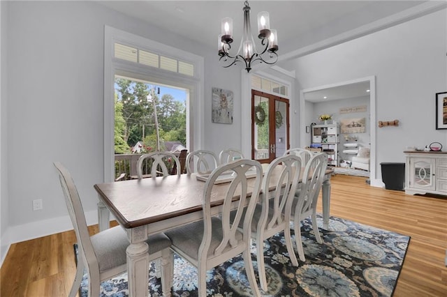 1033 Lanier Ave, Gainesville, GA 30501 - dining area with french doors, an inviting chandelier, and wood finished floors