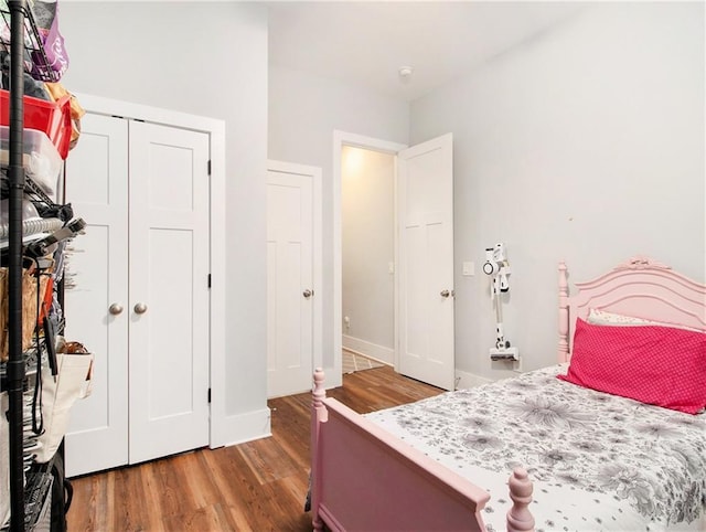 1033 Lanier Ave, Gainesville, GA 30501 - bedroom with a closet, baseboards, and wood finished floors