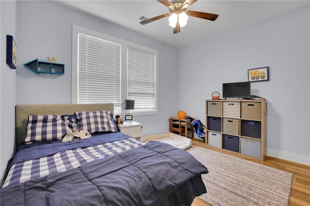 1033 Lanier Ave, Gainesville, GA 30501 - bedroom with ceiling fan, wood finished floors, visible vents, and baseboards