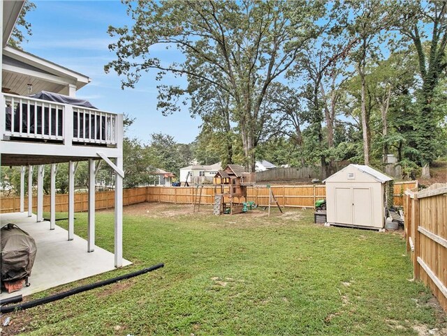 1033 Lanier Ave, Gainesville, GA 30501 - view of yard featuring a fenced backyard, a storage unit, a patio, and an outdoor structure