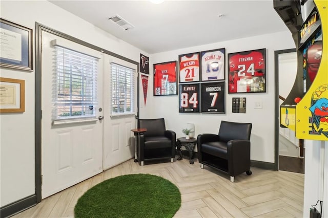 sitting room with visible vents and baseboards