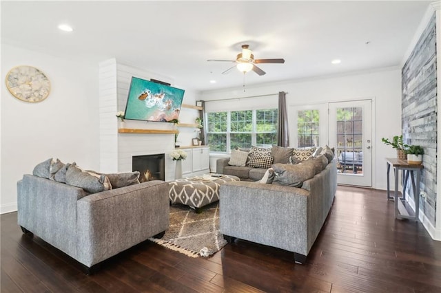 living area with dark wood-style floors, ceiling fan, a fireplace, and recessed lighting