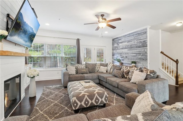 living room featuring dark wood finished floors, recessed lighting, stairway, a ceiling fan, and a glass covered fireplace