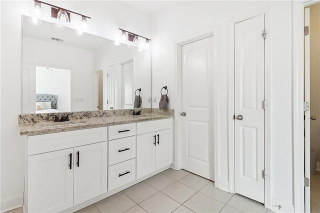 full bathroom featuring double vanity, ensuite bath, tile patterned flooring, and a sink