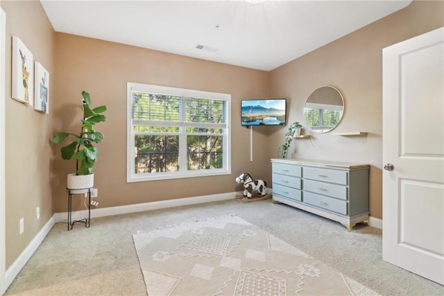 sitting room featuring light carpet, visible vents, and baseboards