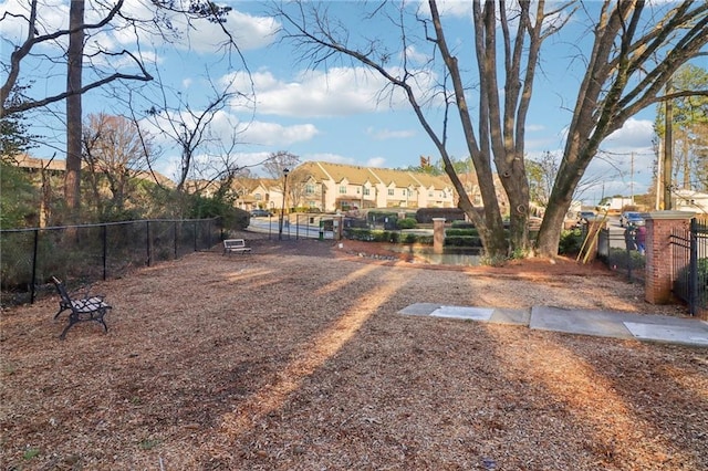 view of yard with a residential view and fence