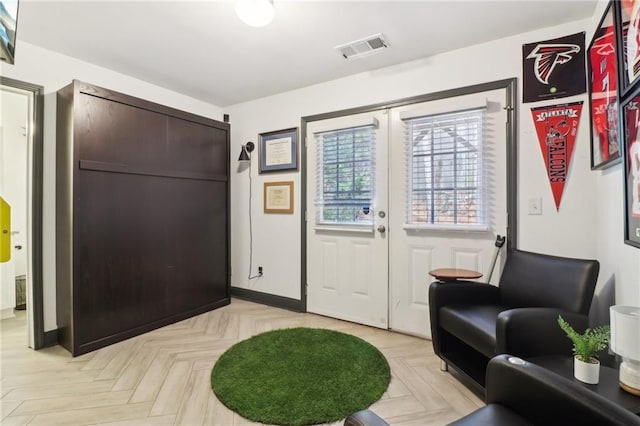 foyer entrance featuring visible vents