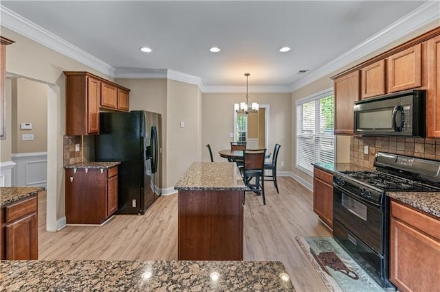 971 Reap Ln, Lawrenceville, GA 30043 - kitchen featuring black appliances, a chandelier, light wood finished floors, dark stone countertops, and decorative backsplash