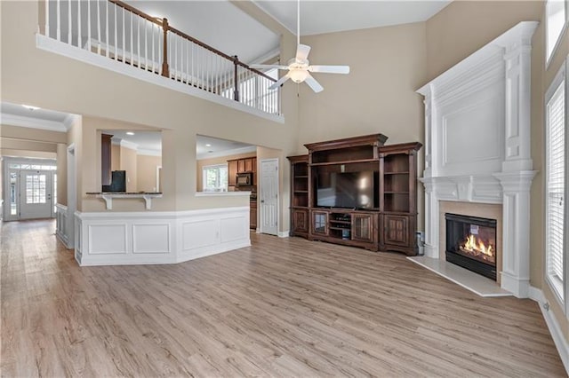 971 Reap Ln, Lawrenceville, GA 30043 - unfurnished living room with ceiling fan, light wood-style flooring, a glass covered fireplace, high vaulted ceiling, and beam ceiling