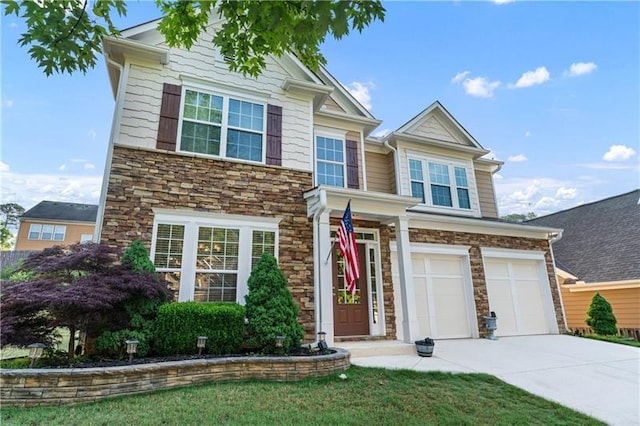 971 Reap Ln, Lawrenceville, GA 30043 - view of front of property with concrete driveway, stone siding, and a garage