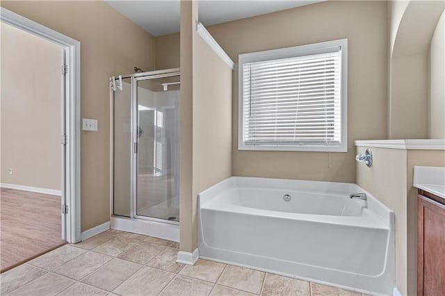 971 Reap Ln, Lawrenceville, GA 30043 - full bath featuring a stall shower, vanity, a bath, and tile patterned floors