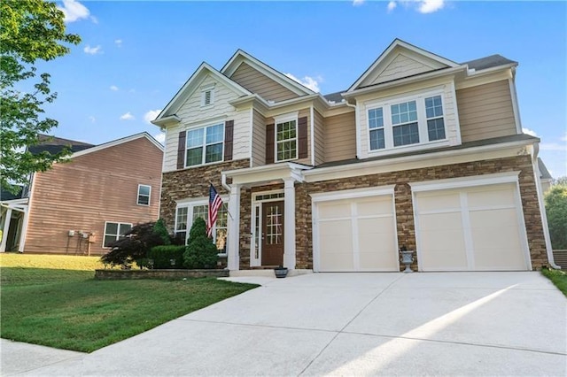 971 Reap Ln, Lawrenceville, GA 30043 - view of front of home featuring stone siding, concrete driveway, a garage, and a front lawn