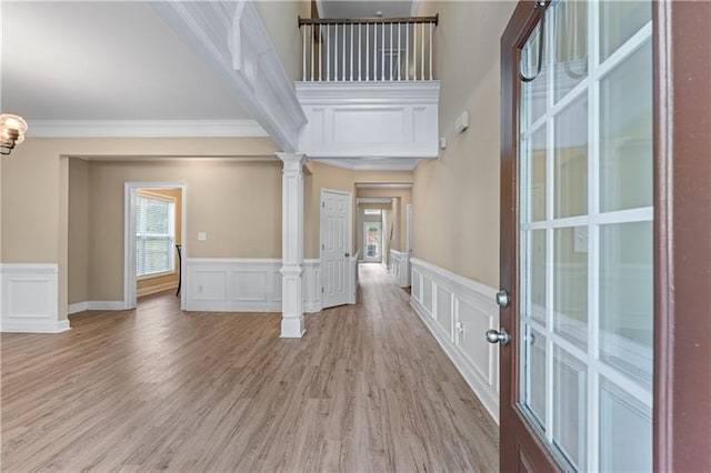 971 Reap Ln, Lawrenceville, GA 30043 - foyer entrance featuring a decorative wall, crown molding, ornate columns, a wainscoted wall, and light wood finished floors
