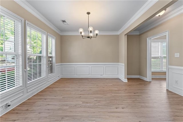 971 Reap Ln, Lawrenceville, GA 30043 - unfurnished room featuring a chandelier, light wood finished floors, ornamental molding, wainscoting, and a decorative wall