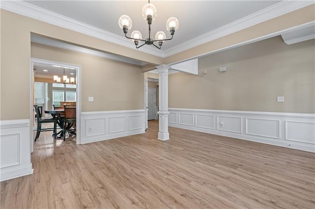 971 Reap Ln, Lawrenceville, GA 30043 - unfurnished room featuring a chandelier, decorative columns, ornamental molding, light wood finished floors, and a wainscoted wall