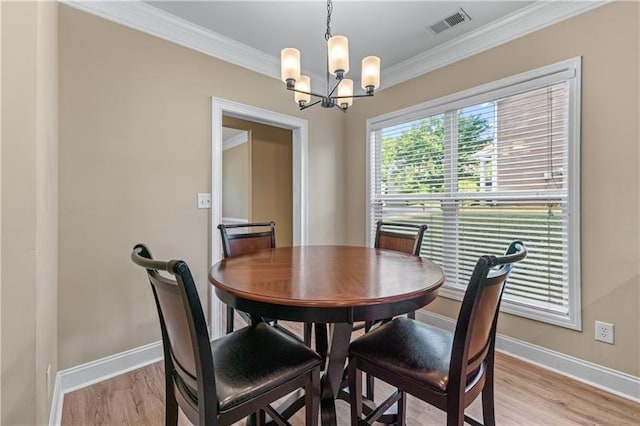 971 Reap Ln, Lawrenceville, GA 30043 - dining space featuring a chandelier, ornamental molding, and light wood-style flooring