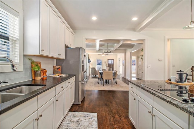 kitchen with beam ceiling, dark wood-type flooring, a sink, coffered ceiling, and white cabinetry