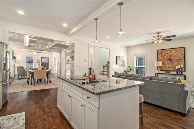 kitchen featuring a ceiling fan, beamed ceiling, dark wood-type flooring, black electric stovetop, and open floor plan