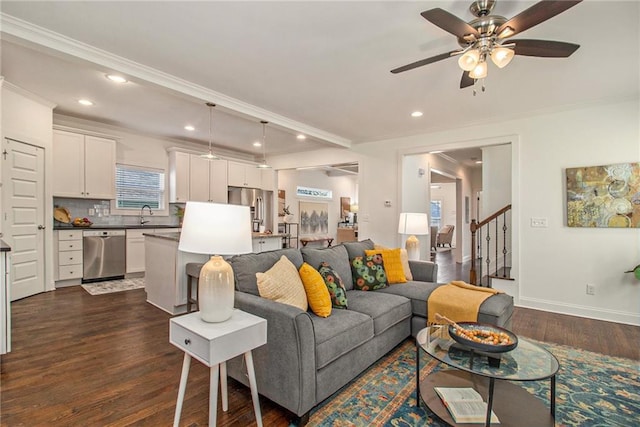 living room with a ceiling fan, crown molding, stairway, and dark wood-style floors