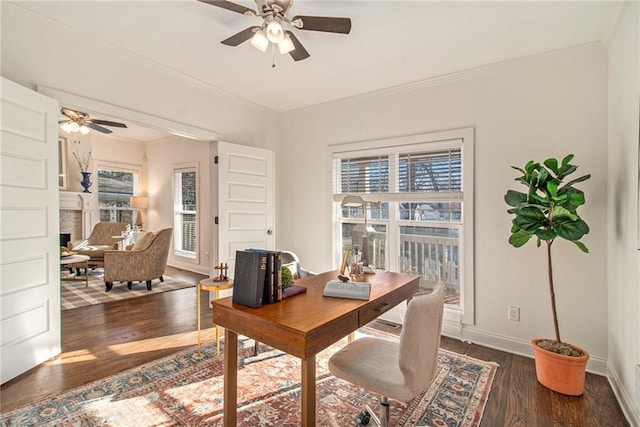 office space featuring a wealth of natural light, baseboards, and a ceiling fan