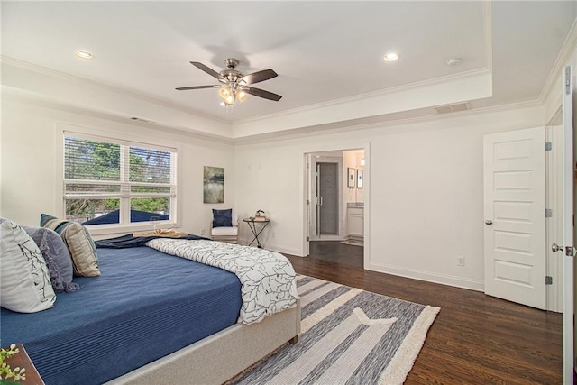 bedroom with a tray ceiling, baseboards, dark wood-style flooring, and crown molding