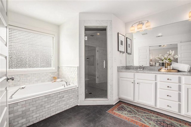 bathroom with tile patterned floors, a garden tub, a stall shower, and vanity