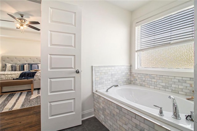 full bathroom featuring tile patterned flooring, ensuite bath, a bath, and a ceiling fan