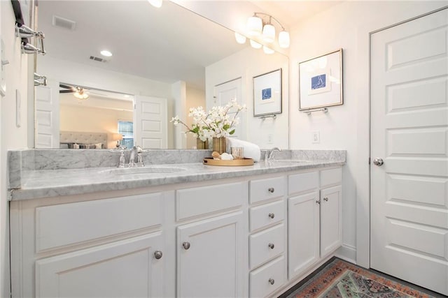 full bathroom with a sink, visible vents, and double vanity