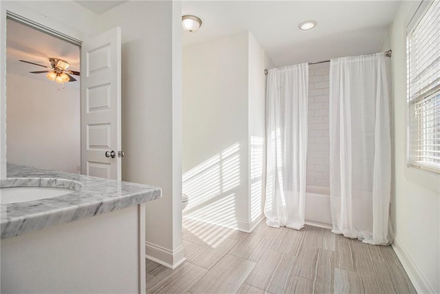 full bath with baseboards, shower / bath combo with shower curtain, ceiling fan, and vanity