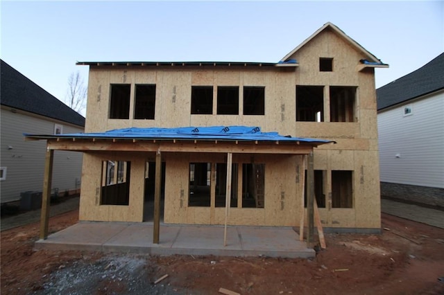 back of property featuring central air condition unit and a patio