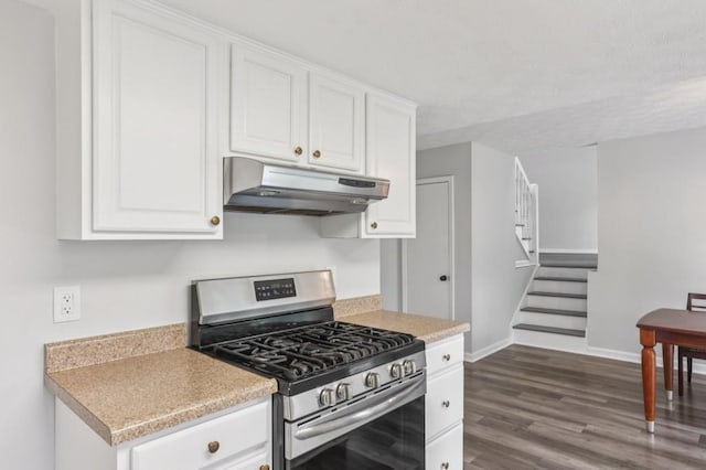 6249 Townsend Way, Riverdale, GA 30296 - kitchen with stainless steel gas stove, under cabinet range hood, white cabinetry, and dark wood-style floors