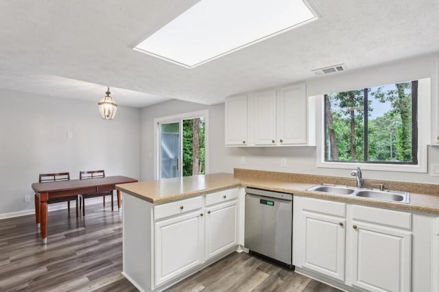 6249 Townsend Way, Riverdale, GA 30296 - kitchen featuring stainless steel dishwasher, a peninsula, white cabinetry, wood finished floors, and a textured ceiling