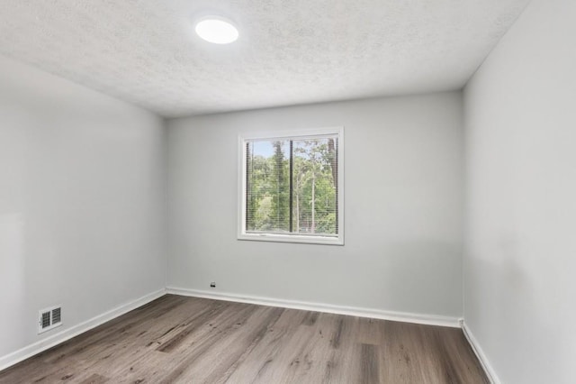 6249 Townsend Way, Riverdale, GA 30296 - spare room with a textured ceiling and wood finished floors