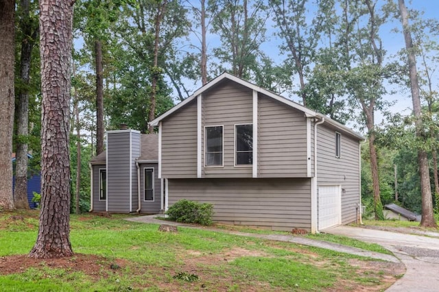 6249 Townsend Way, Riverdale, GA 30296 - split level home with concrete driveway, a chimney, an attached garage, and a front yard