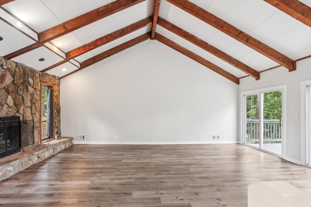 6249 Townsend Way, Riverdale, GA 30296 - unfurnished living room featuring beamed ceiling, wood finished floors, a stone fireplace, recessed lighting, and high vaulted ceiling