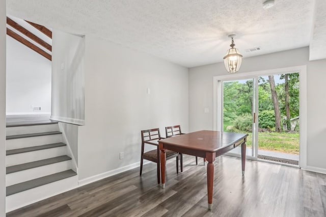 6249 Townsend Way, Riverdale, GA 30296 - dining room with wood finished floors, a textured ceiling, and stairs