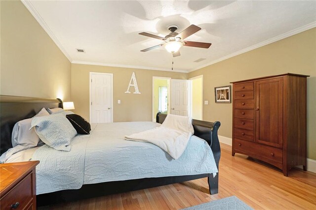 5020 Huntshire Ln SW, Lilburn, GA 30047 - bedroom with light wood-style floors, ornamental molding, and a ceiling fan