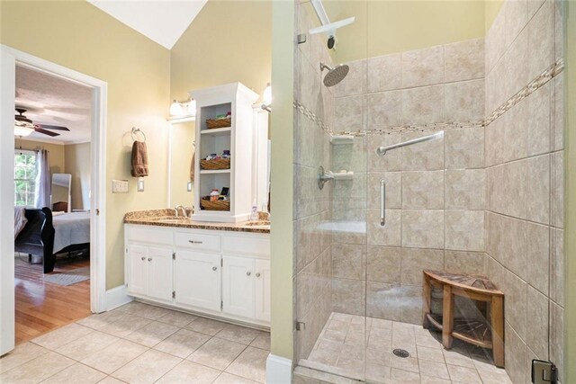 5020 Huntshire Ln SW, Lilburn, GA 30047 - bathroom featuring connected bathroom, a shower stall, vanity, a ceiling fan, and tile patterned flooring