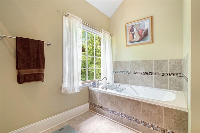 5020 Huntshire Ln SW, Lilburn, GA 30047 - bathroom with tile patterned floors, a bath, and vaulted ceiling
