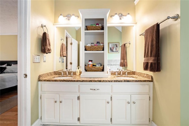 5020 Huntshire Ln SW, Lilburn, GA 30047 - bathroom with ensuite bathroom, double vanity, and wood finished floors