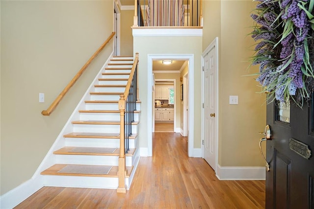 5020 Huntshire Ln SW, Lilburn, GA 30047 - entryway featuring stairway, light wood-type flooring, and crown molding