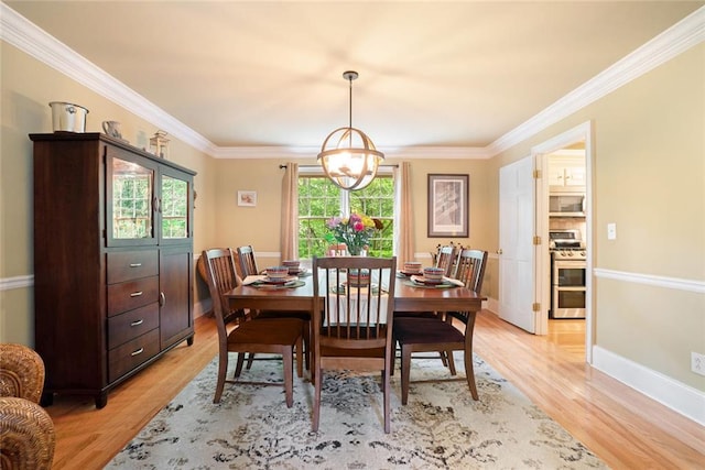 5020 Huntshire Ln SW, Lilburn, GA 30047 - dining area with light wood finished floors, crown molding, and a chandelier