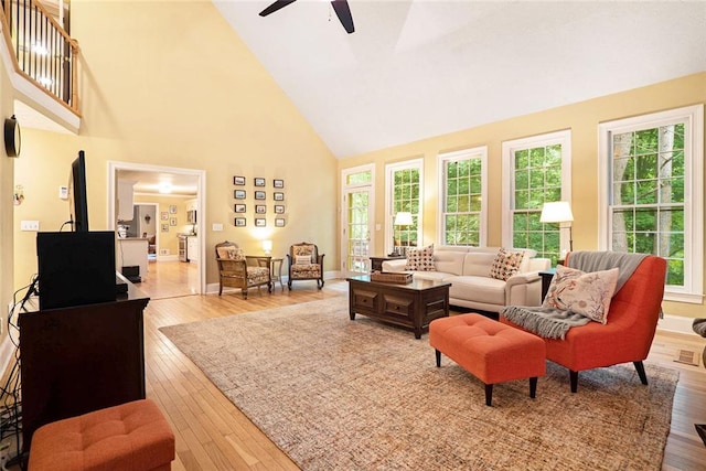 5020 Huntshire Ln SW, Lilburn, GA 30047 - living room with high vaulted ceiling, ceiling fan, and wood-type flooring