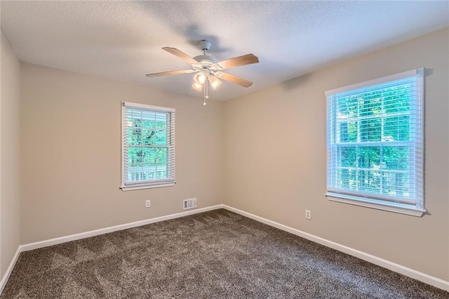62 Sweetwater Pkwy, Powder Springs, GA 30127 - empty room featuring ceiling fan, dark carpet, baseboards, and a textured ceiling